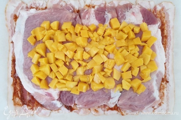 На свинину выкладываем нарезанное кубиками свежее манго.