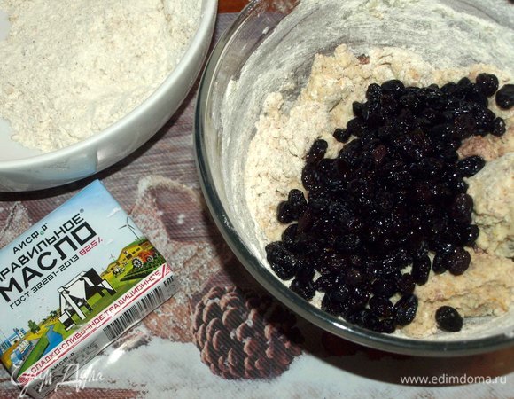 Добавить часть муки к сливочно-творожной смеси. Добавить подготовленный изюм. Перемешать.