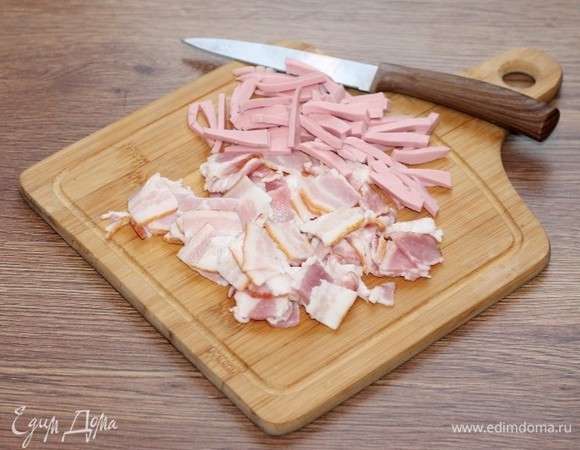 Полоски бекона нарезать небольшими кусочками. От себя, я добавила немного вареной колбасы (50 г).