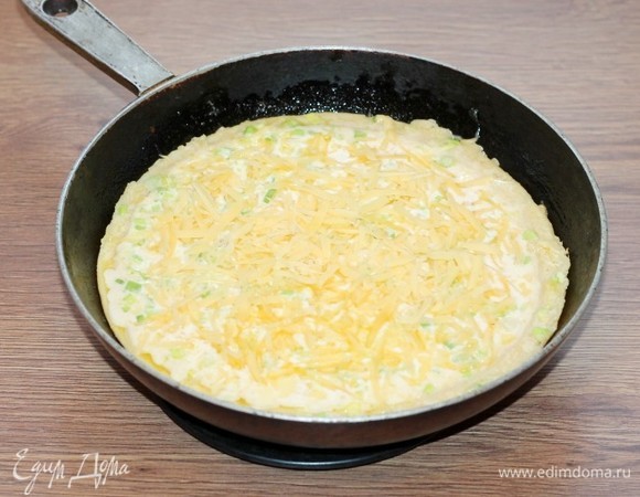 Посыпать верх пирога-запеканки натертым на терке твердым сыром.