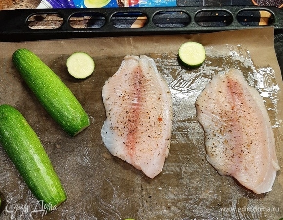 На противень, смазанный маслом, выложить рыбу и цукини.