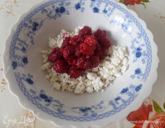 Готовим начинку. В чашку выкладываем творог, малину и 1 ст. л. сахара (малину предварительно разморозила). Хорошо перемешиваем.
