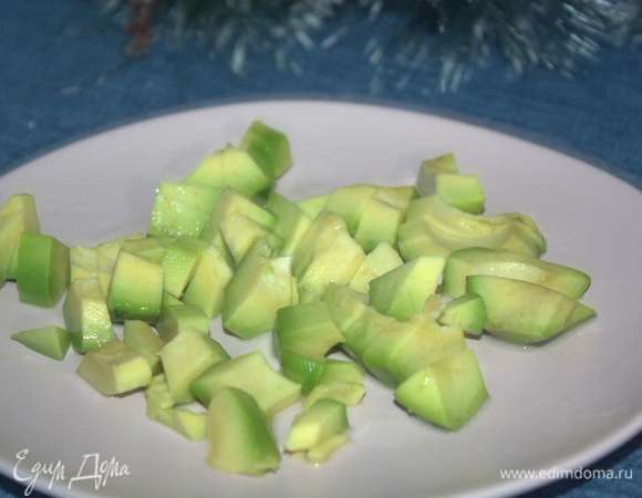 Приготовим крем из авокадо. Авокадо вымыть, обсушить бумажным полотенцем, очистить, разрезать пополам и вырезать косточку. Мякоть мелко нарезать и сбрызнуть лимонным соком.