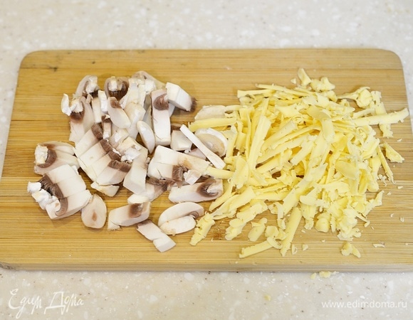 Грибы произвольно нарежьте, сыр натрите на терке.