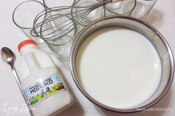 В сотейник выложить йогурт-закваску, добавить немного молока, тщательно перемешать венчиком. Затем добавить все оставшееся молоко и перемешать еще раз.