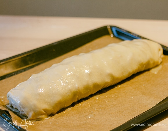 Аккуратно перенести на противень, застеленный пергаментной бумагой. Смазать штрудель растопленным сливочным маслом.