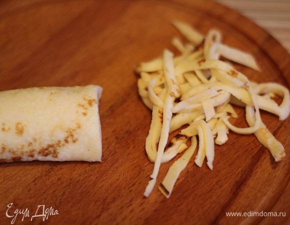 Блинчики сворачиваем в трубочку и нарезаем тонкой лапшой.