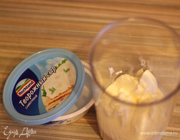 Для крема смешиваем творожный сыр Hochland, сливки, сахарную пудру. Взбиваем до однородного воздушного состояния. Перекладываем в кондитерский мешок с той же насадкой, из которой отсаживали бортики основы.