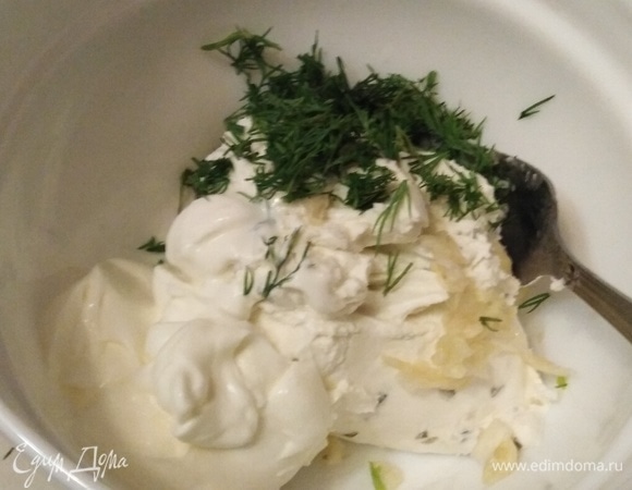 Творожный сыр Hochland смешать с натертым зубчиком чеснока, укропом и сметаной.