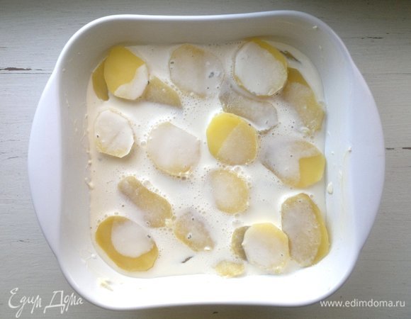 В форму с картофелем вылить половину заливки.