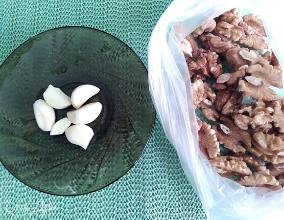 Приготовить орехи и очищенный чеснок.