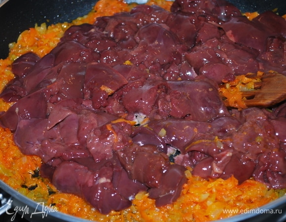 К обжаренному луку и моркови добавьте куриную печень, предварительно очищенную от пленки и нарезанную на кусочки. Протушите все вместе до готовности печени в течение 7–9 минут.