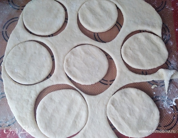 Припылить мукой стол, раскатать тесто, вырезать стаканом лепешки.