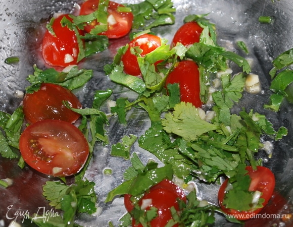 Пока перец запекается, помидоры черри нарежьте на половинки и перемешайте с чайной ложкой оливкового масла. Добавьте свежую кинзу, свежемолотый черный перец, половинку зубчика чеснока (мелко нарезанного) и чайную ложку лимонного сока, посолите по вкусу.