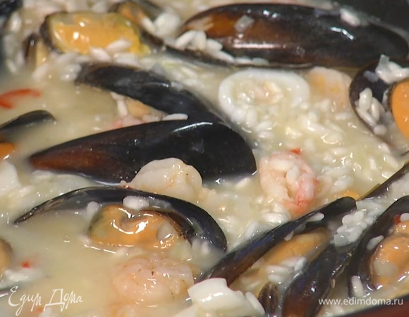 Добавить в сотейник свежие морепродукты. Готовить в течение 16–18 минут на небольшом огне, постепенно вливая остатки бульона и постоянно помешивая.