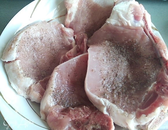 Подготовить свиные антрекоты. Посолить и поперчить по вкусу с обеих сторон.