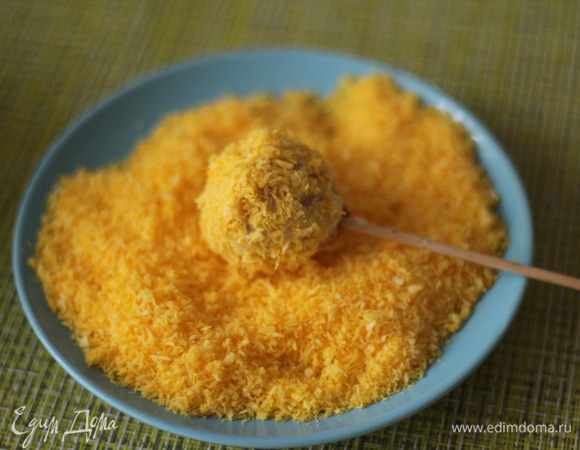 Затем шарик обваливаем в желтой кокосовой стружке.