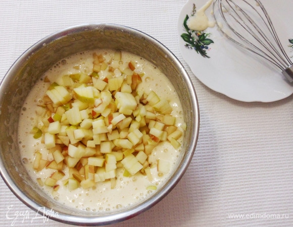 Добавить яблоки, нарезанные мелким кубиком. Яблоки лучше взять кислых сортов. Аккуратно перемешать смесь ложкой для равномерного распределения яблок.