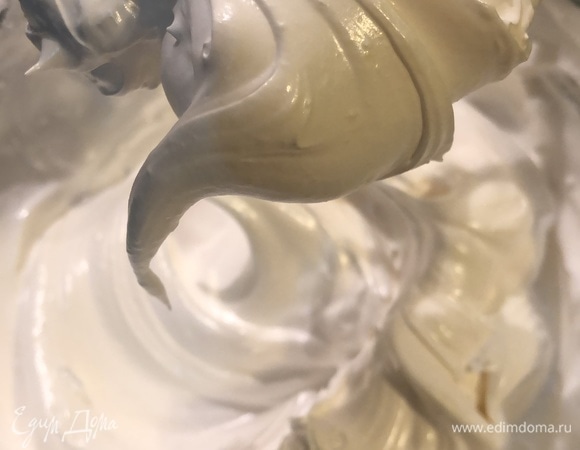 Сироп аккуратно влить в белки, непрерывно взбивая до крепких пиков, примерно 10 минут.