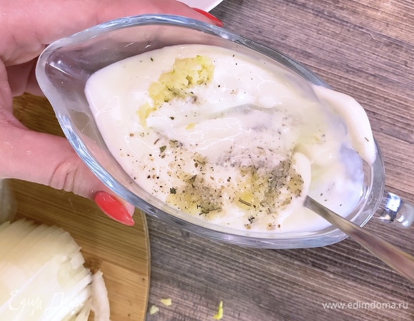 В сметану выдавить чеснок, добавить соль и перемешать.