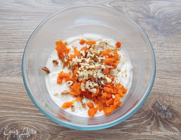 Грецкие орехи немного прокалите на сухой сковороде, порубите и добавьте в миску с курагой и взбитой массой. Все перемешайте и влейте распущенный желатин, быстро перемешивая.