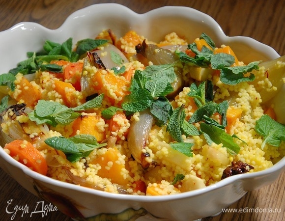 В запаренный кускус добавить овощи вместе с выделившимся соком, все перемешать, переложить в глубокое блюдо и посыпать листьями мяты.