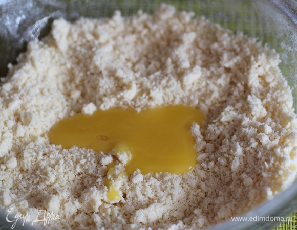 Добавить яичный желток и быстро собрать тесто в шар. Если плохо собирается, добавить 1 ст. л. ледяной воды, не больше! Тесто должно получиться чуть липковатое.