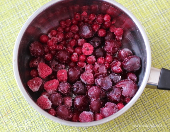 Замороженные ягоды выложить в сотейник с толстым дном, добавить сахар, поставить на средний огонь и довести до кипения, добавить крахмал, как следует размешать, чтобы не было комочков.