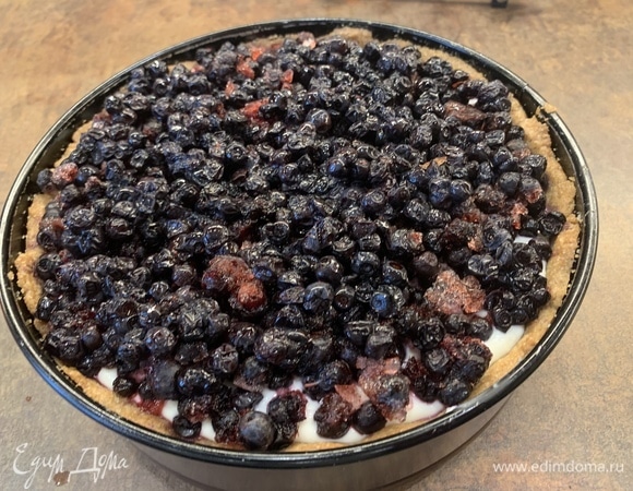 Выложите сверху ягоды (советую не использовать клубнику и малину, они могу не пережить почти час в духовке). Поставьте в разогретую до 180–185°C духовку. У меня стакан замороженной черники из морозилки. Прямо со льдом.