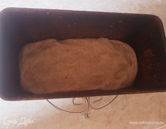 Выложить тесто в форму для выпечки и оставить на 30 минут. Смазать верх водой и посыпать кунжутом или семечками. Выпекать первые 10 минут при 240°C. Потом понизить температуру до 200°C и выпекать еще 30 минут.