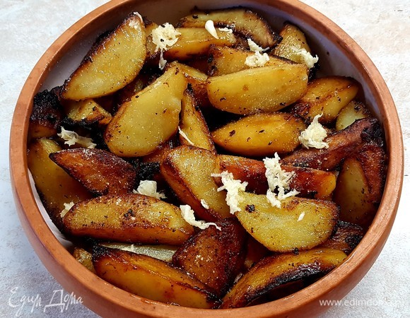 На индейку выложить картофель и тоже посыпать чесноком и специями с солью.