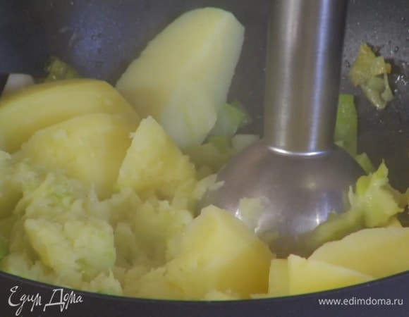 Отваренный картофель выложить в сковороду с луком и чесноком, снять с огня и измельчить все погружным блендером, влить молоко, посолить и снова взбить, затем влить 50‒70 мл воды, в которой варился картофель, и взбить в гладкую массу без комочков.