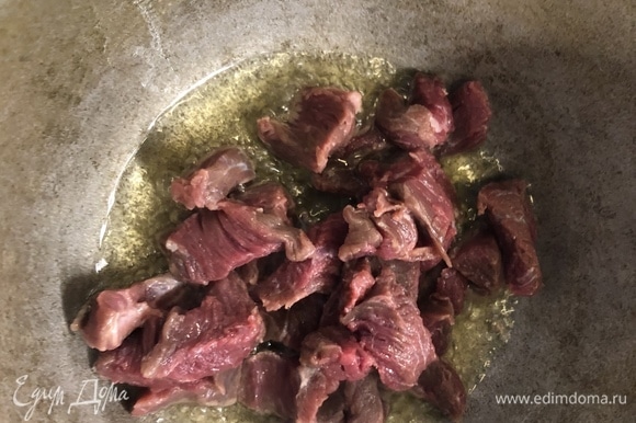 На дно толстой кастрюли заливаем оливковое и рафинированное масло (1:1), добавляем говядину, жарим.