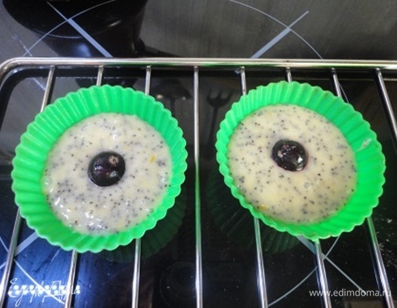 Всыпать сухие ингредиенты к жидким и перемешать. Выложить в формочки, получится примерно 10–12 шт. Сверху — по одной ягоде. У меня смородина. У автора была малина.