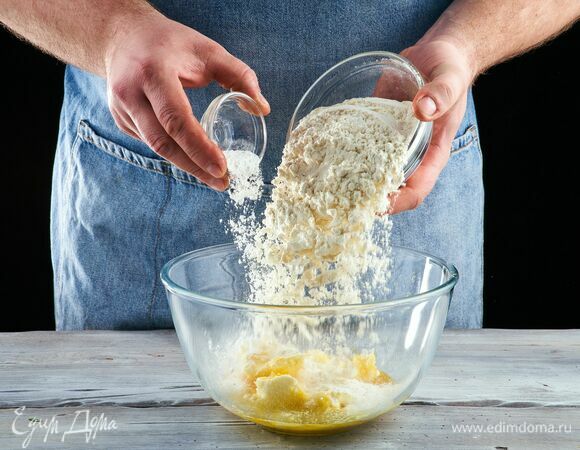 Всыпьте муку, сахар, разрыхлитель и замесите мягкое тесто.