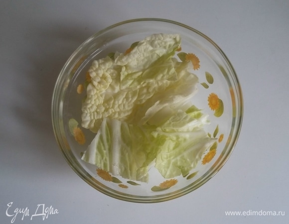 На дно глубой емкости надо положить слой нарезанных листьев китайского салата.