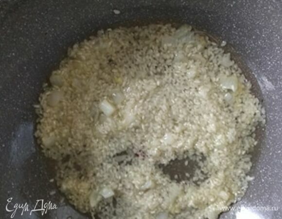 В разогретую сухую сковороду положить сухой рис. Обжарить одну минуту, влить вино и выпарить, постоянно помешивая. Добавить лук и влить одну поварешку горячего бульона. Готовить рис на среднем огне, постоянно помешивая и вливая по поварешке бульона по мере выпаривания. Рис нельзя оставлять ни на минуту. Весь процесс занимает минут 20–25, зависит от сорта риса.