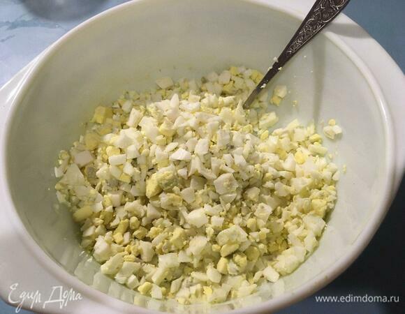 Высыпаем нарезанные яйца к заправке.