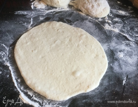 На припыленном мукой столе раскатайте каждый шар в пласт толщиной 0,5 см.