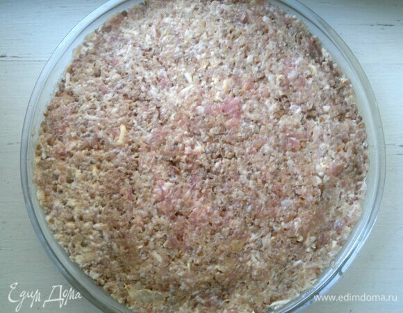 В форму для запекания выложить мясной фарш с добавками, разровнять.
