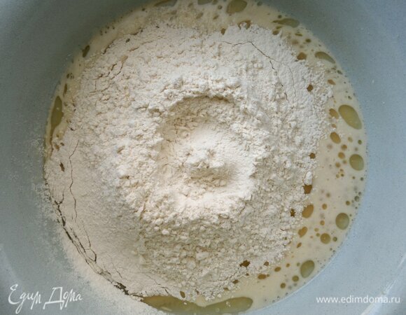 Частями всыпать просеянную муку и замесить тесто.