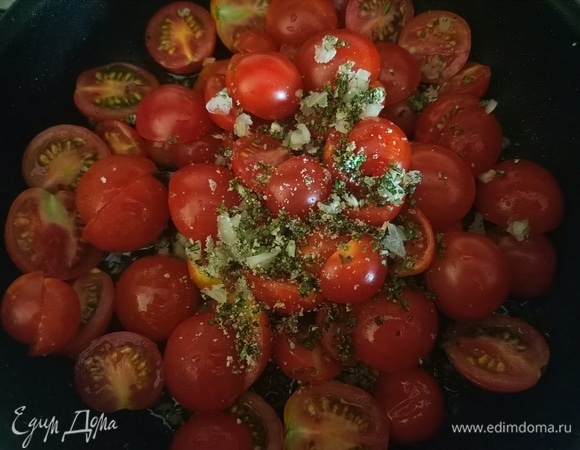 Пока рыба запекается, делаем гарнир. В сковороду наливаем немного оливкового масла, добавляем измельченный чеснок, помидоры и зелень, что мы отложили в начале, солим и обжариваем на слабом огне в течение 5–6 минут.