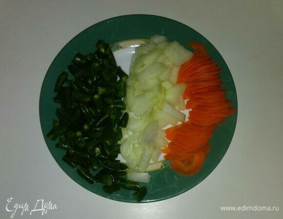 Стручковую фасоль нужно разрезать на несколько частей. Репчатый лук мелко порубить. Морковь нужно разрезать вдоль пополам, а затем нарезать тонкими дольками.