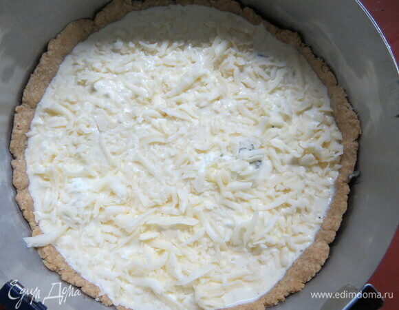 Выложить всю начинку на основу, сверху — заливка и тертый сыр.