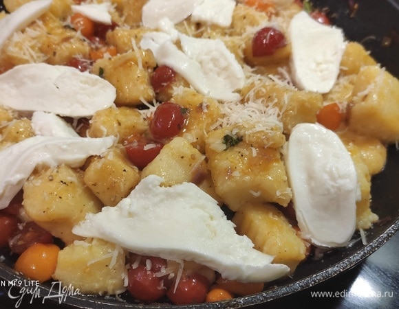 Духовку разогреть до 220°C. Ньокки посыпать натертым сыром (подойдет любой твердый сыр) и выложить кусочки моцареллы. Запекать 10 минут, пока сыр не расплавится.