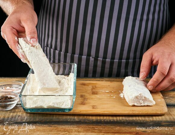 В неглубокой миске смешайте соль, перец и муку. Обваляйте треску с каждой стороны в мучной смеси.