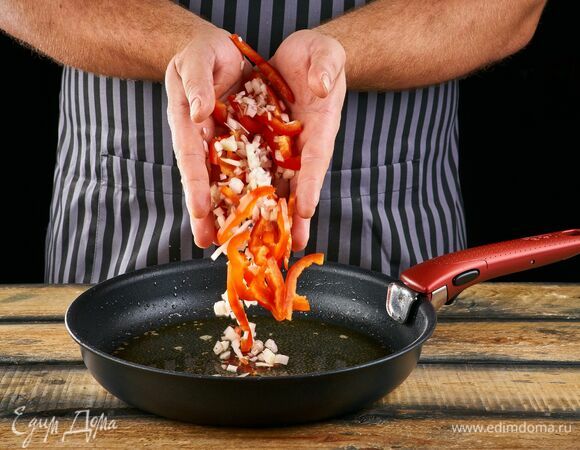 Добавьте в сковороду болгарский перец, нарезанный тонкими ломтиками, и лук, нарезанный кольцами. Жарьте в течение 3 минут.