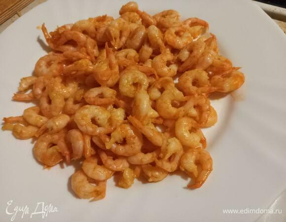 Перекладываем поджаренные креветки на отдельную тарелку.