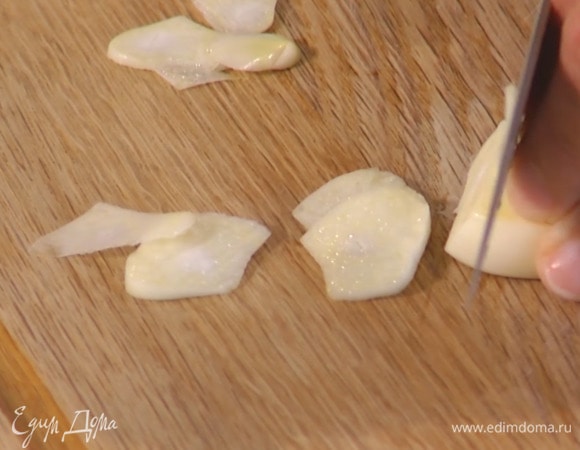 Чеснок почистить и нарезать тонкими пластинками.