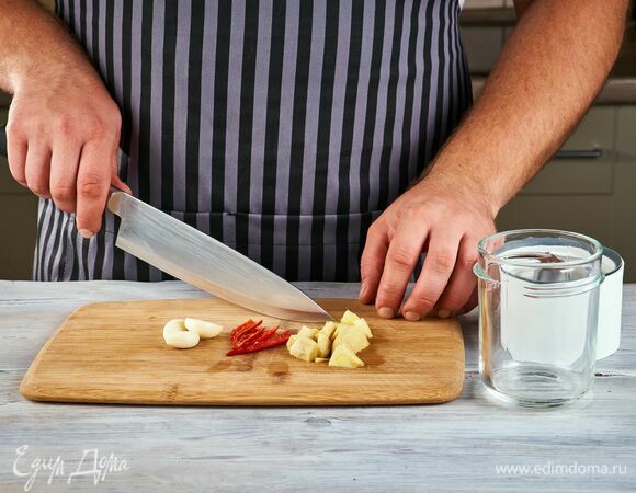 Приготовьте соус. Чеснок почистите, перец чили разрежьте пополам и удалите семена, с имбиря снимите шкурку.